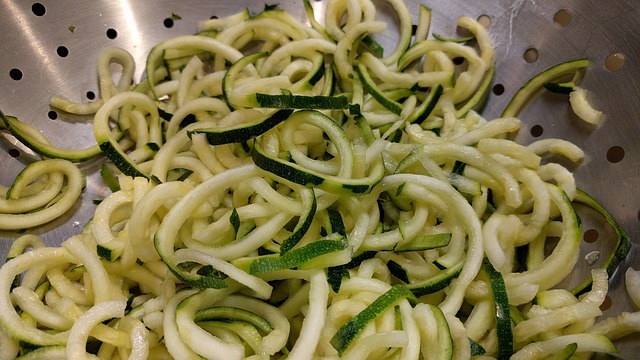cooked zucchini noodles in a strainer