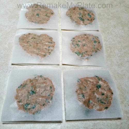 Cilantro Chicken Burger mixture made into premade patties and stored on squares of waxed paper.