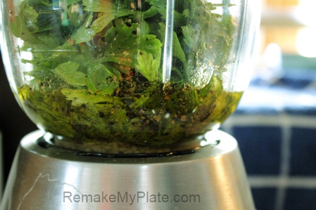 processing the cilantro and basil in the blender