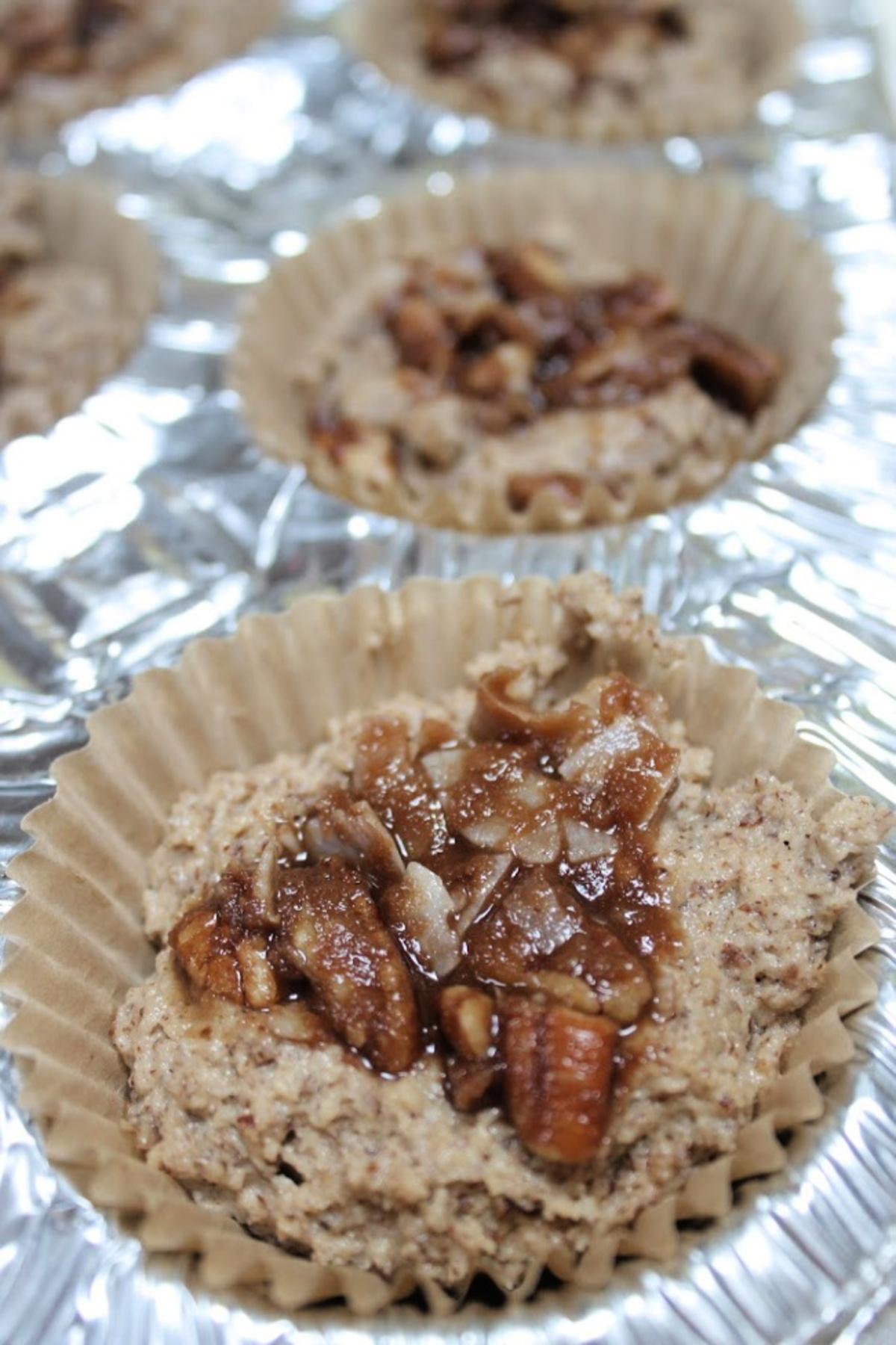 Adding praline topping to the muffin mix
