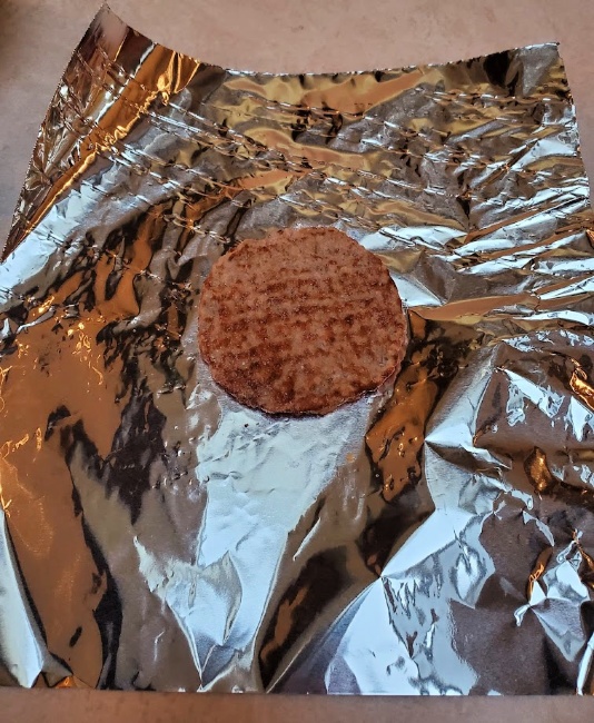 sausage patty on sheet of foil