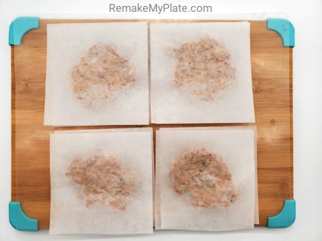 place a second piece of parchment paper on top of the salmon mixture