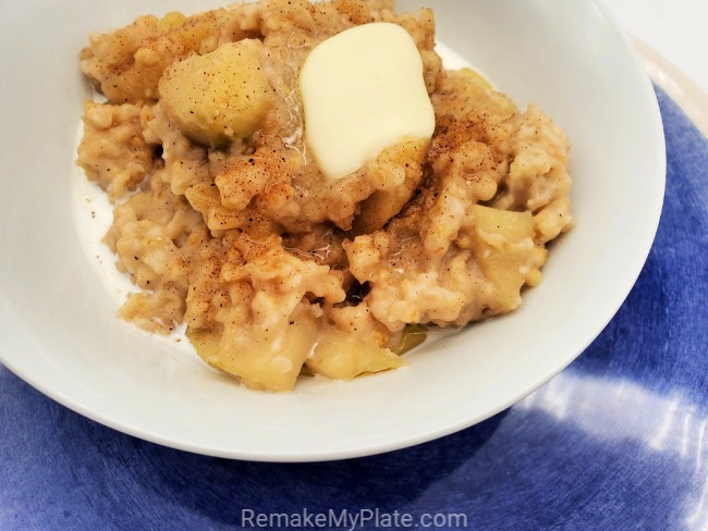serve up this delicious apple slow cooker oatmeal topped with a pat of butter and a bit of cream