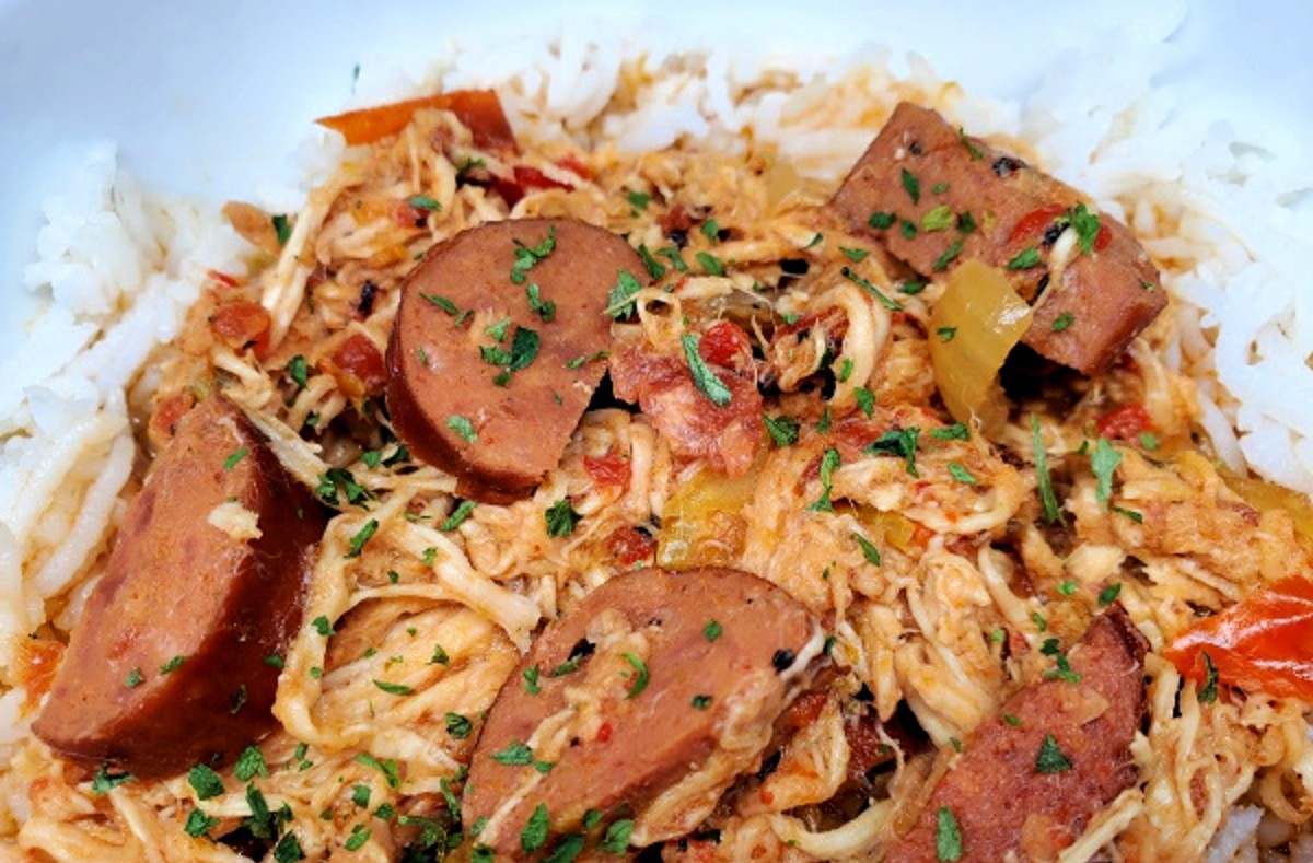 cajun chicken and sausage over rice in a bowl