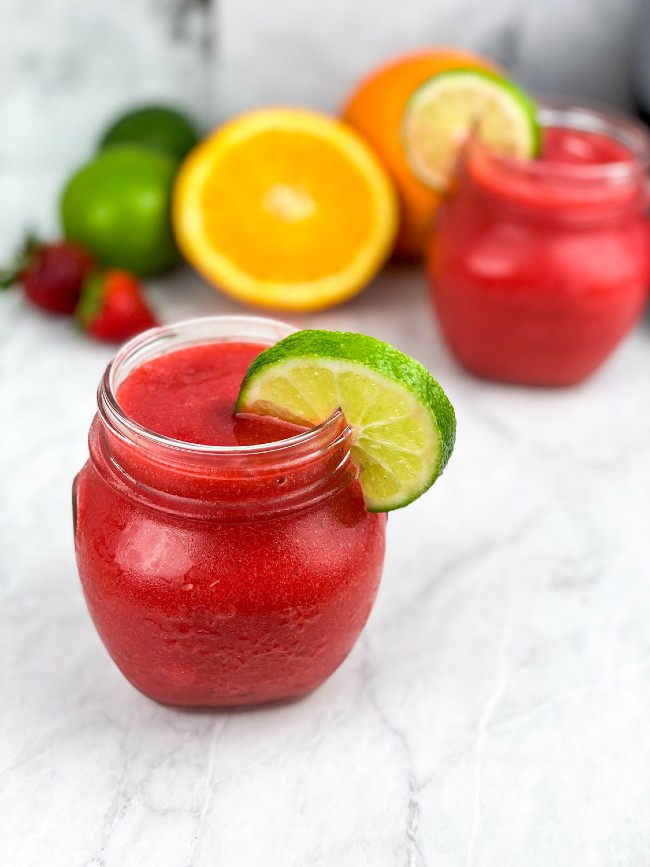 low carb frozen strawberry daiquiri in glasses garnished with lime slices