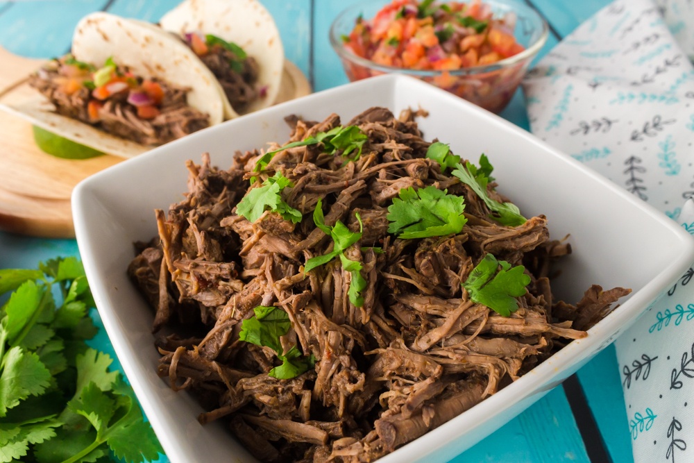 easy to make crock pot copycat Chipotle barbacoa beef in a serving dish