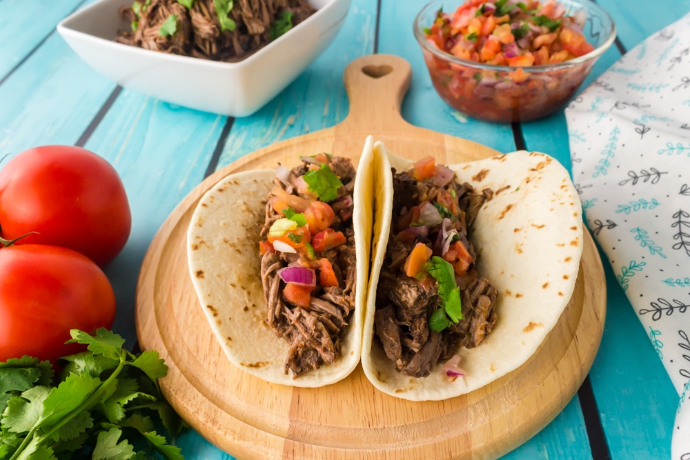 barbacoa beef soft tacos on a serving board