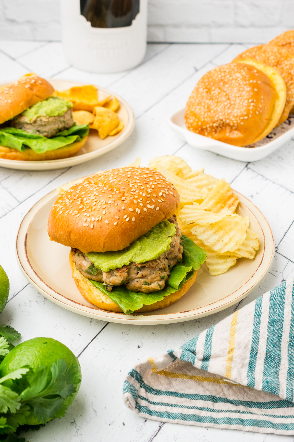 cilantro lime chicken burgers topped with avocado on a plate