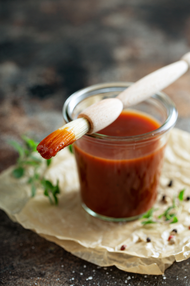 keto BBQ sauce in a jar with a brush for the sauce
