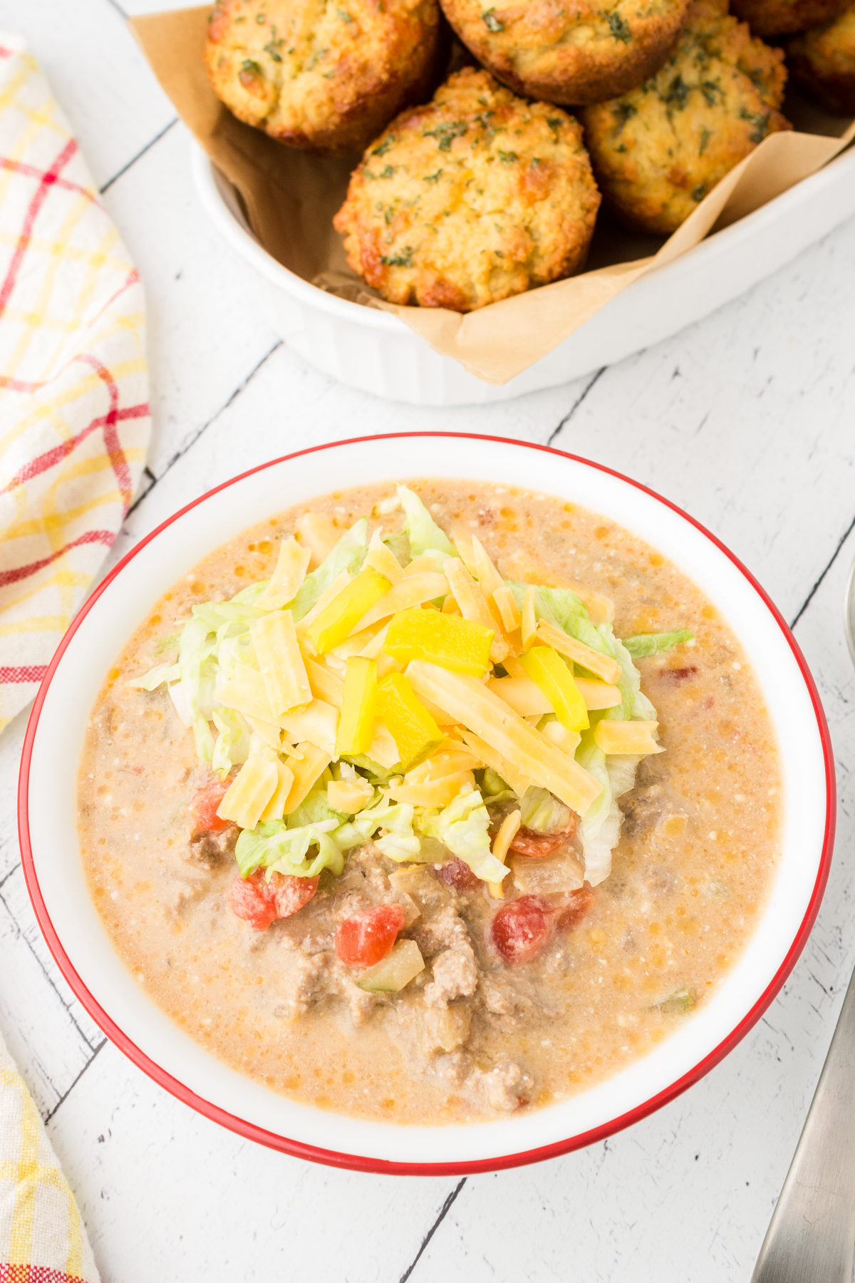 keto cheeseburger soup in a bowl with keto cheddar biscuits