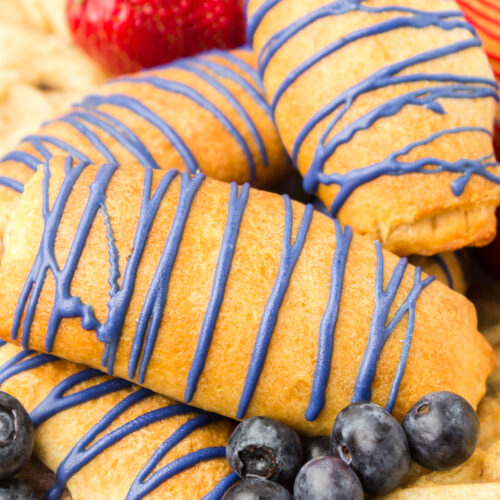 blueberry cream cheese crescent rolls on a breakfast grazing board