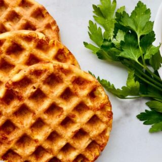Keto Cornbread Chaffles featured 3 fanned chaffles on the left and right is a partial bowl of chili w parsley e1623872803574.jpgfit12002c676ssl1