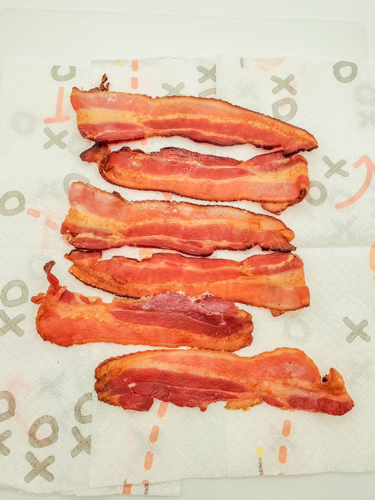 to freeze place cooked strips of bacon on paper towels