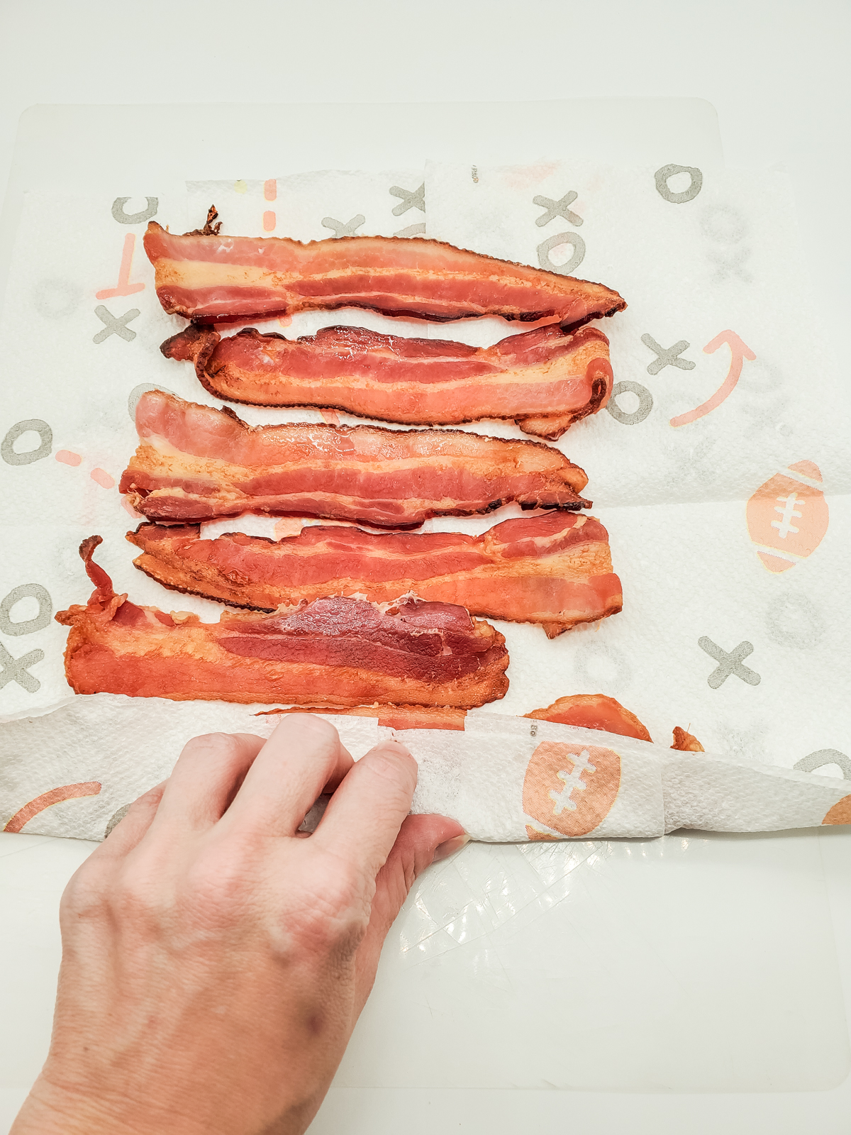 roll the strips of cooked bacon up in the paper towels