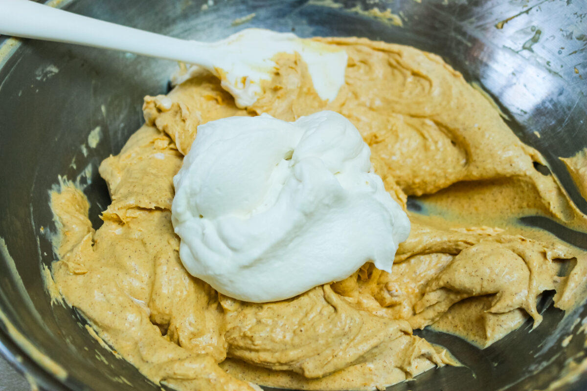folding the whipped cream into the pumpkin mixture