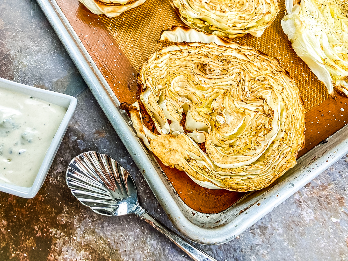 roasted cabbage steaks on a baking sheet