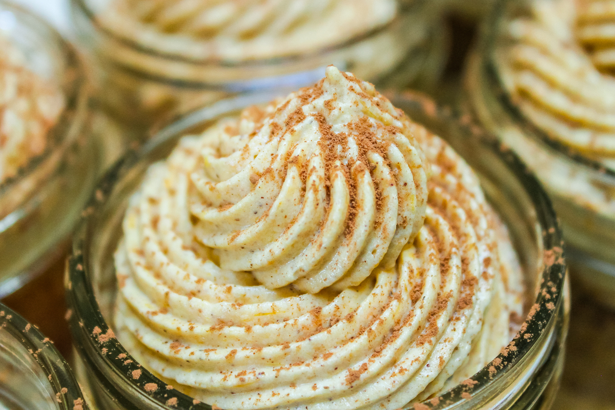 sprinkling cocoa powder on top of the pumpkin tiramisu 