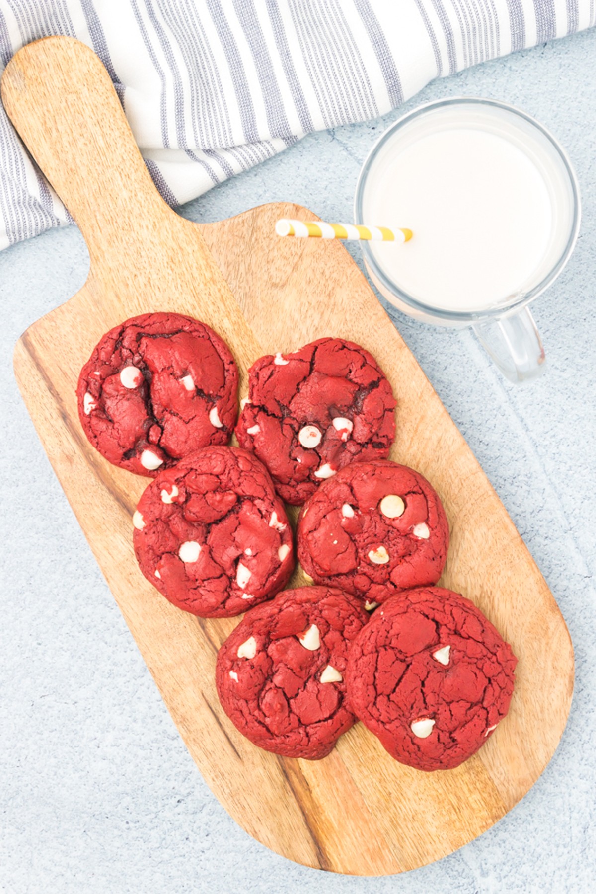 stack of red velvet cookies on a cutting board