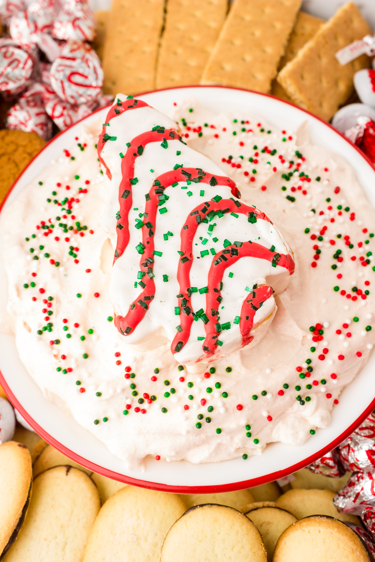 christmas tree dip surrounded by milano cookies, graham crackers and other cookies