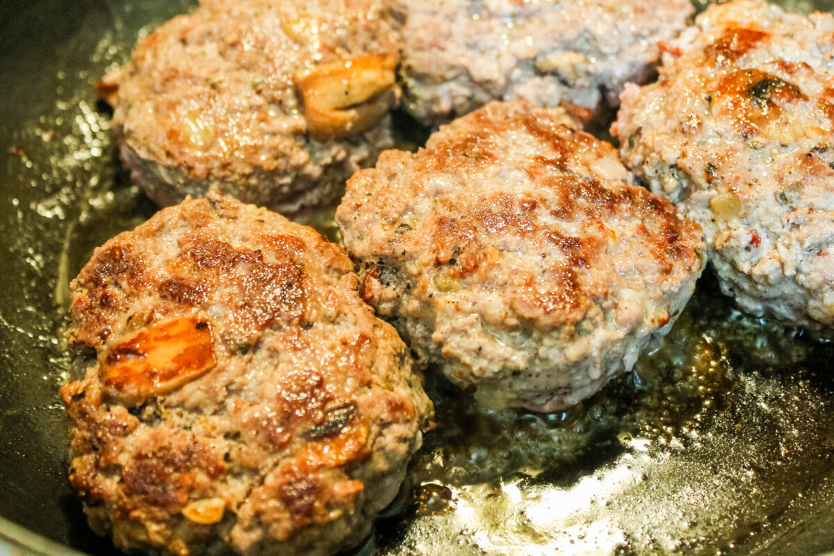 browning the ground beef patties in a skillet