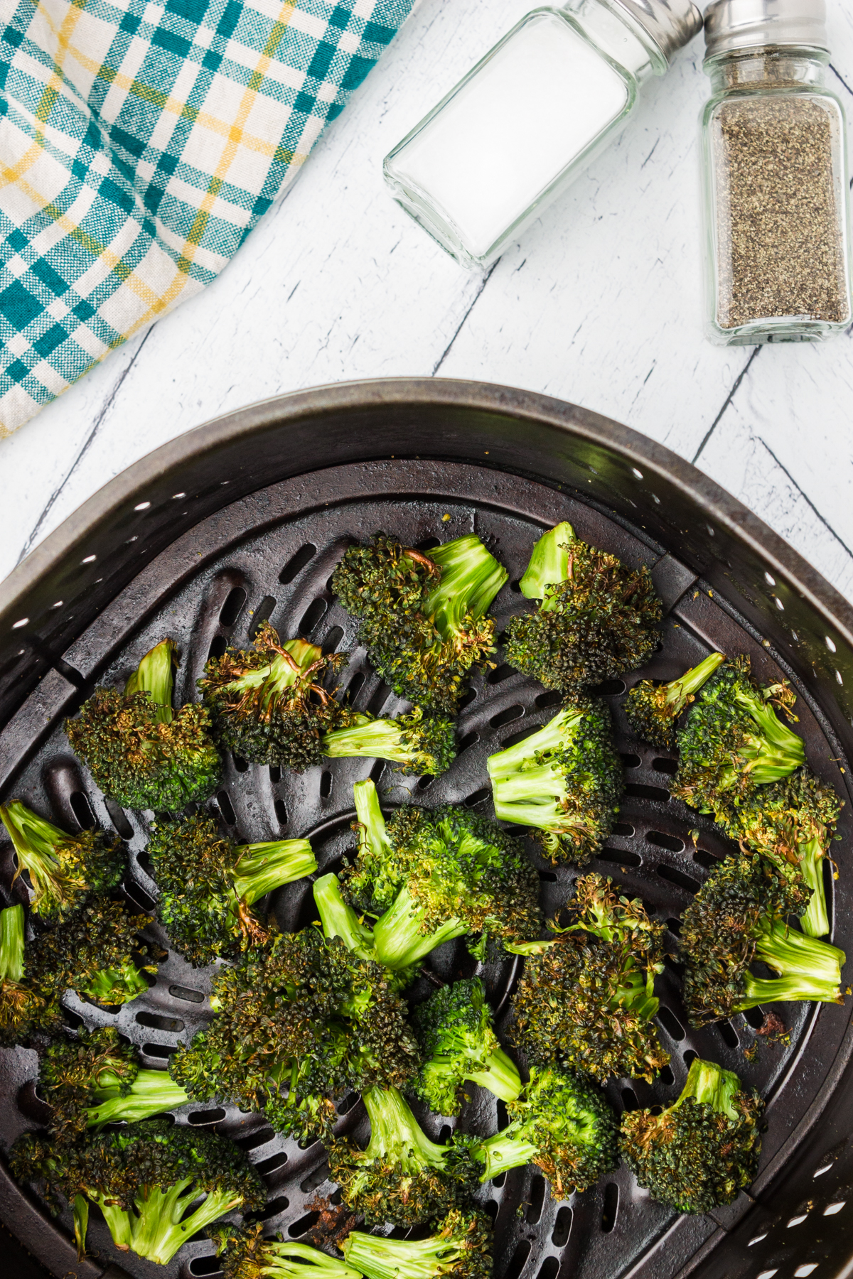 roasted broccoli in the air fryer showing several charred or burnt broccoli florets 