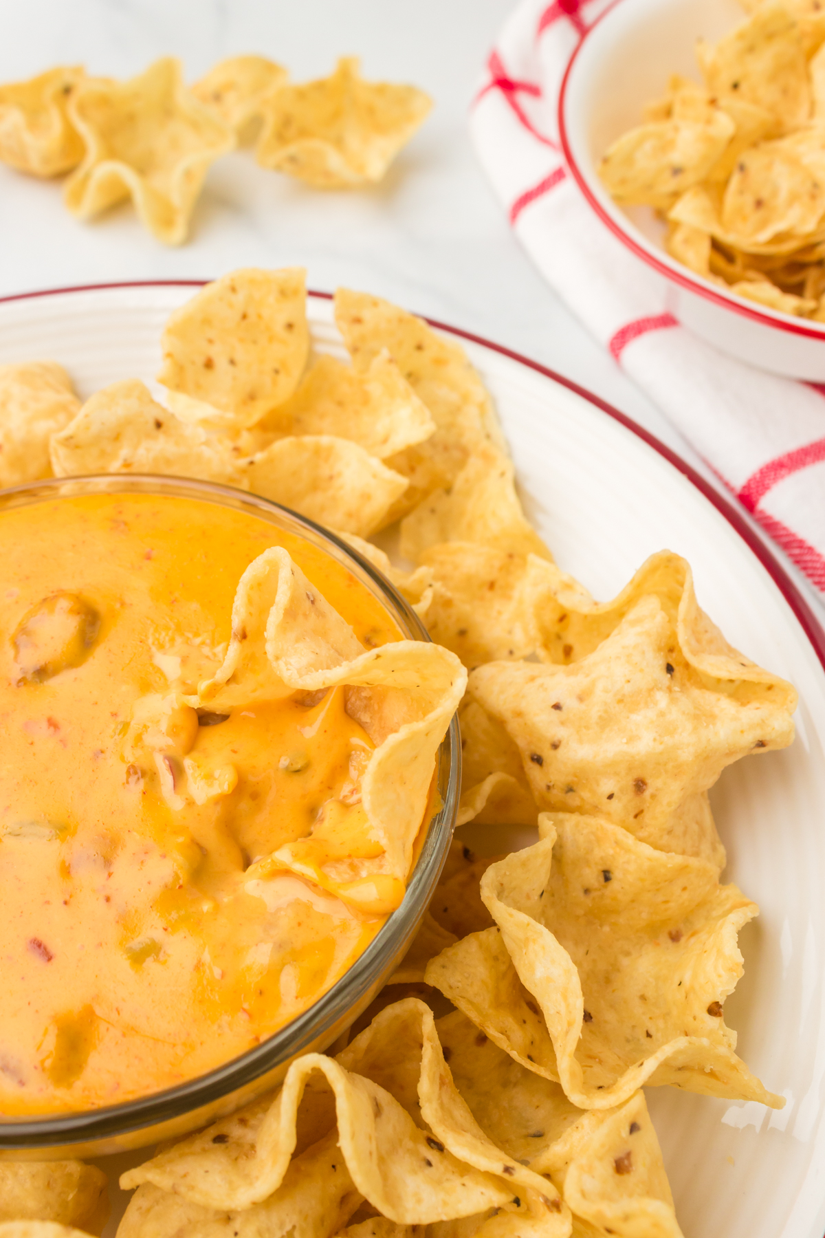 tortilla chip dipped into 3-ingredient chili cheese dip 