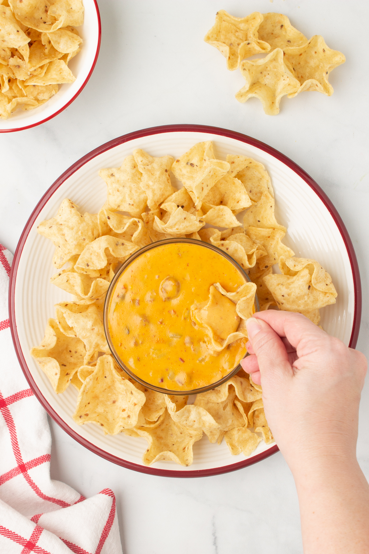 dipping into hormel chili dip with tortilla chips 