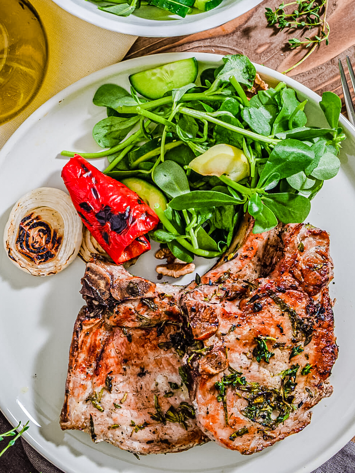 rosemary pork chops with salad on a plate