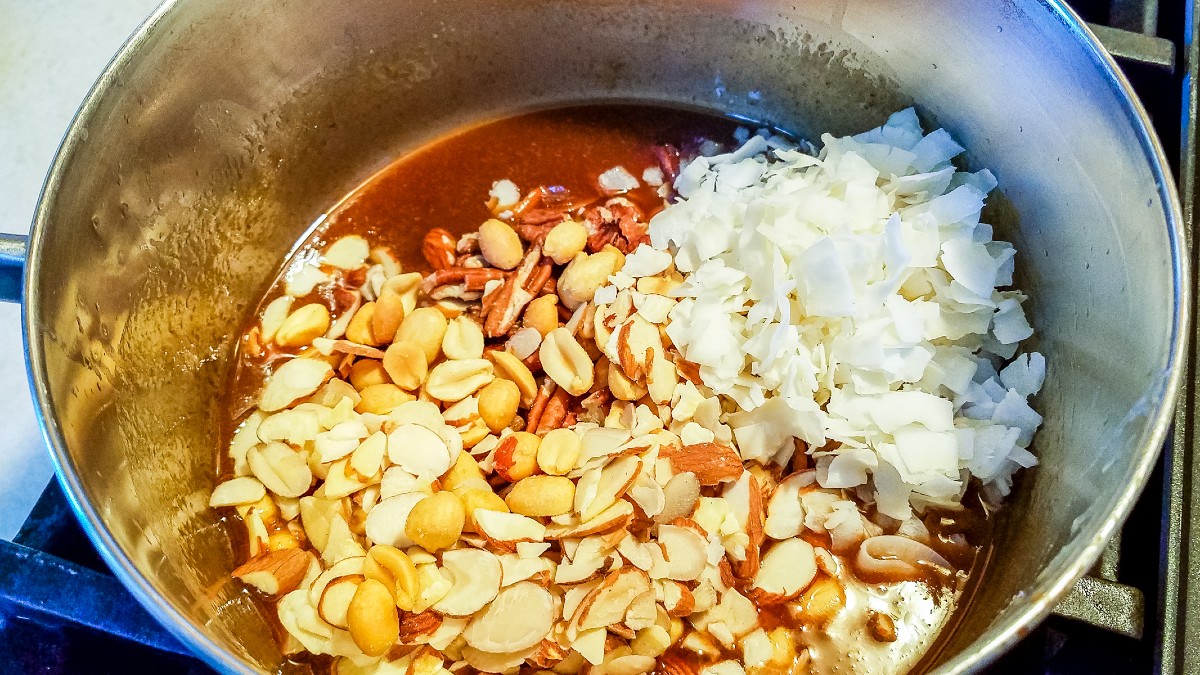 mixing in the chopped nuts and coconut flakes into this keto praline candy