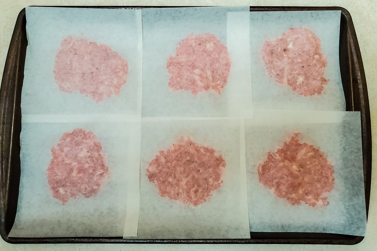 covering breakfast sausage mixture with second piece of waxed paper