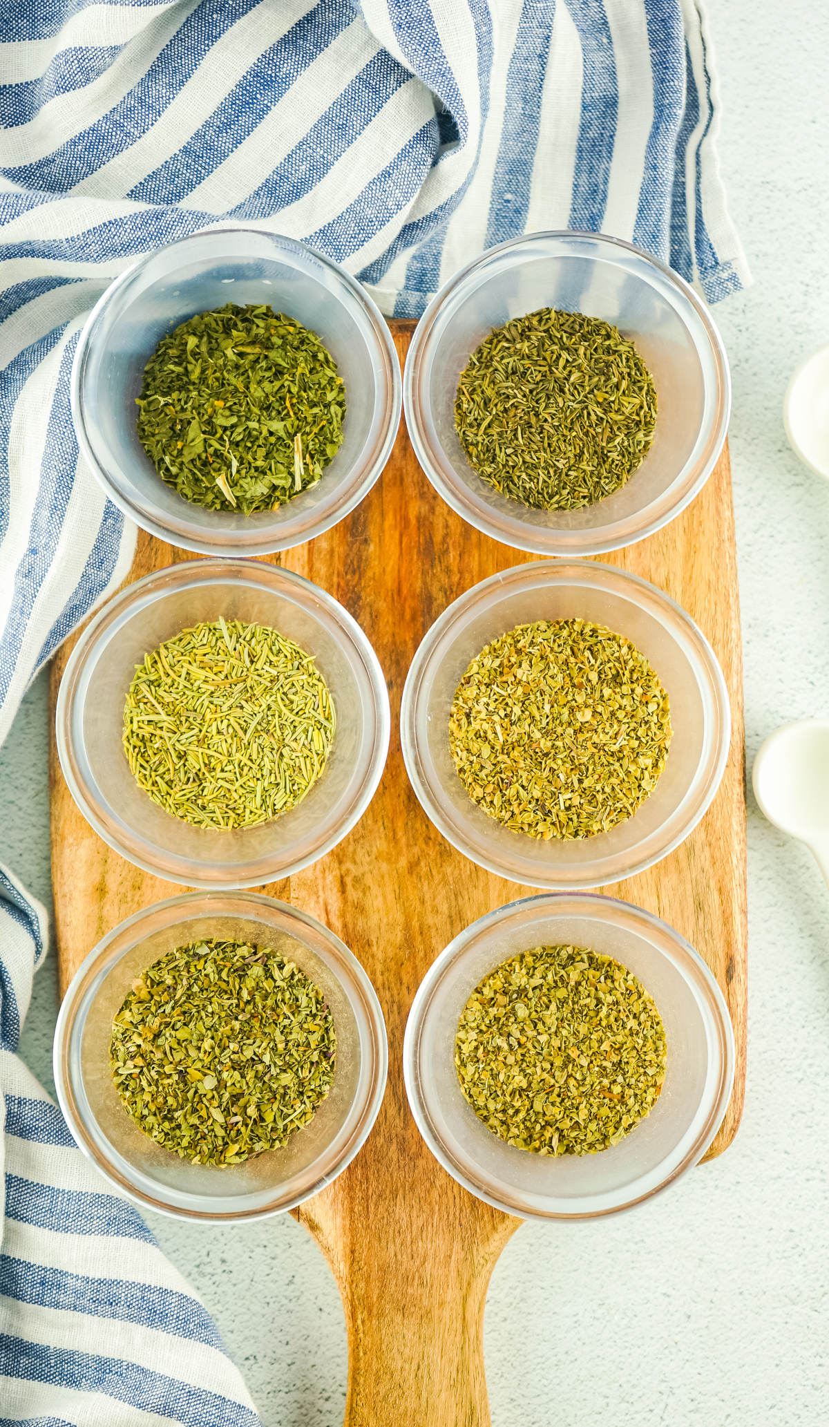 dried herbs in bowls to give food delicious Italian flavors