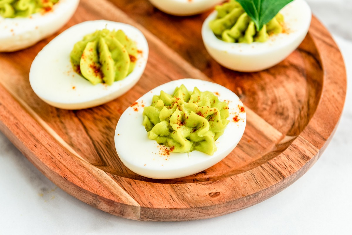 easy to make healthy avocado deviled eggs on a cutting board