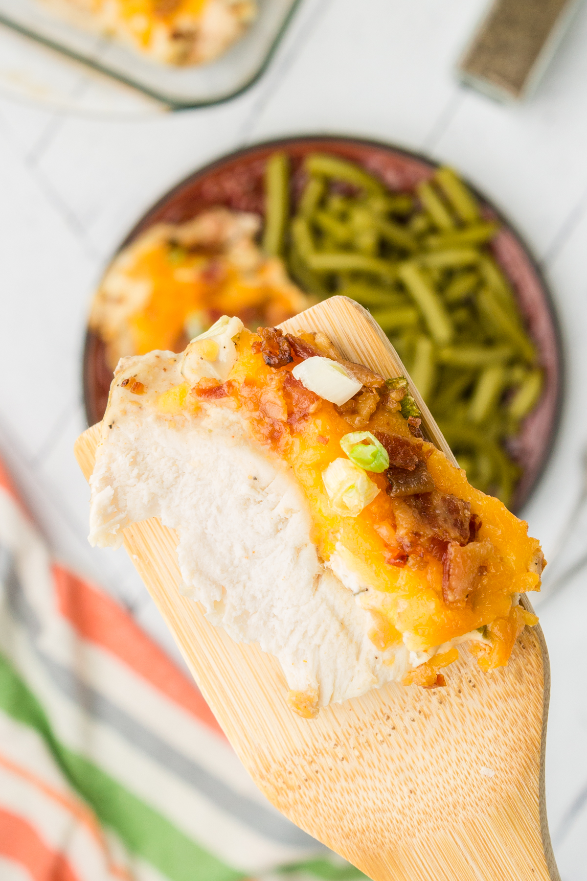 slice of easy baked crack chicken on a spatula