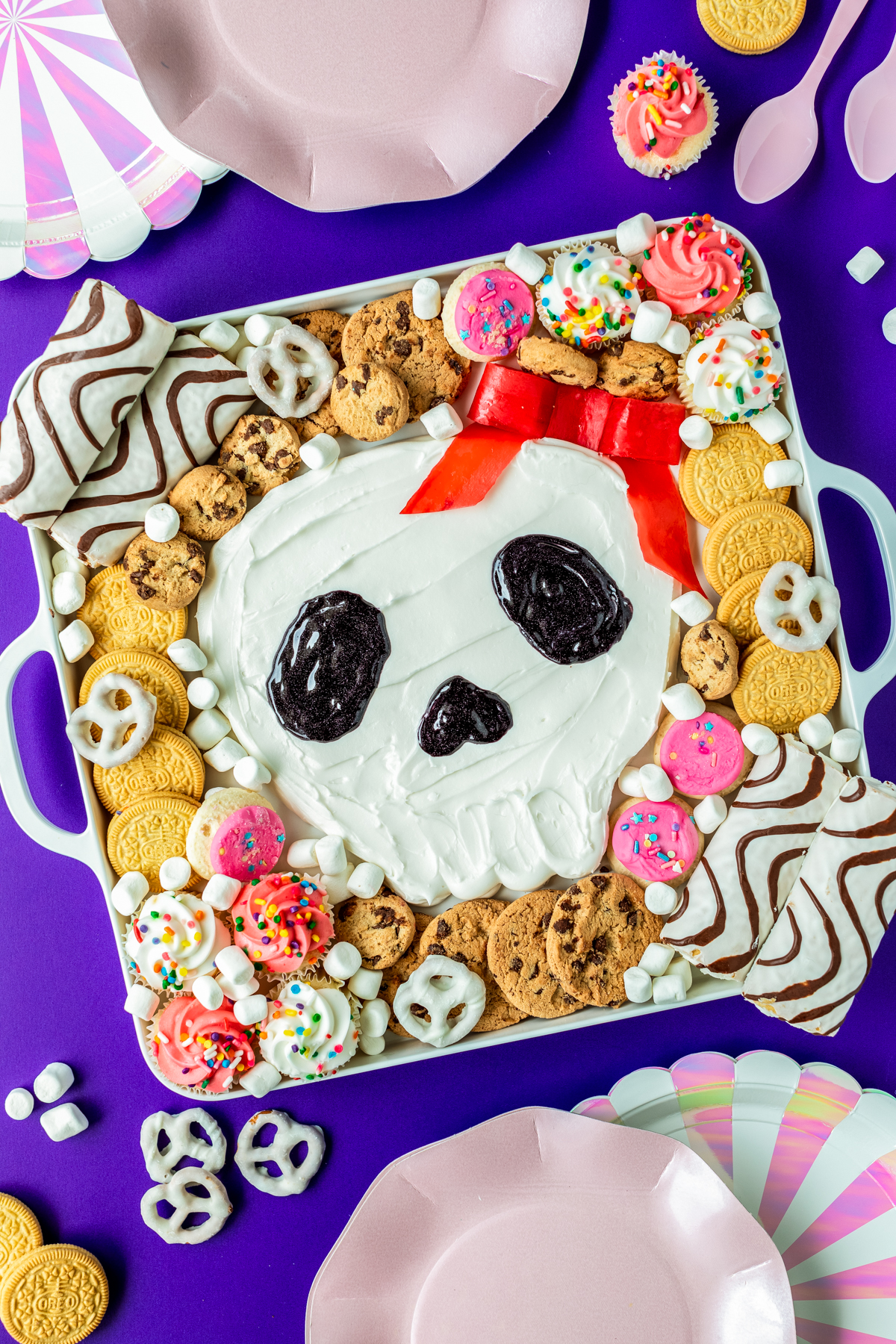 easy to make halloween charcuterie board skull shaped frosting board on a serving tray