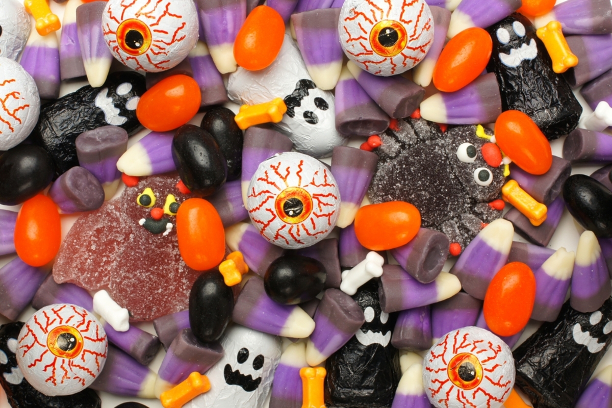 Assortment of Halloween candy including colorful candy corn and black jelly beans