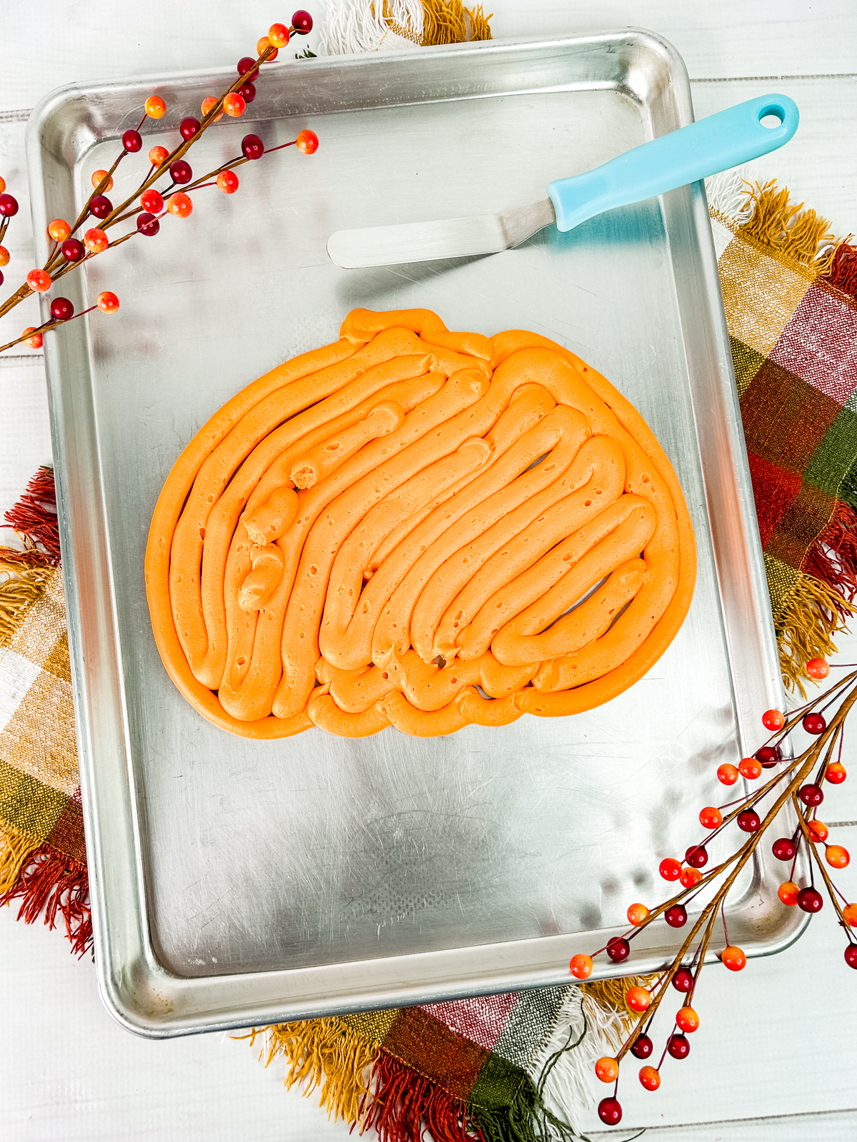 filling in the pumpkin outline with additional american buttercream
