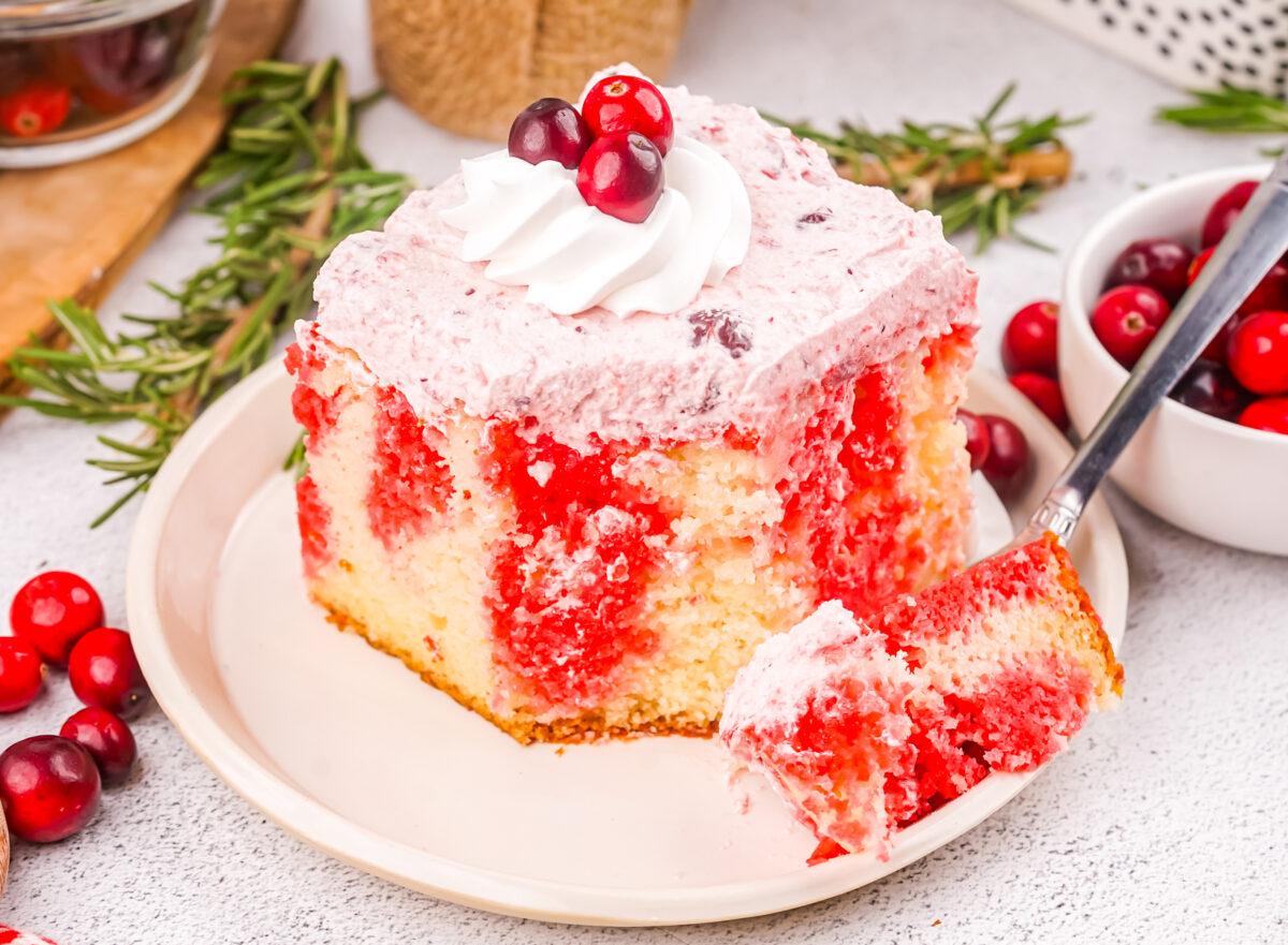 slice of cranberry poke cake on a plate