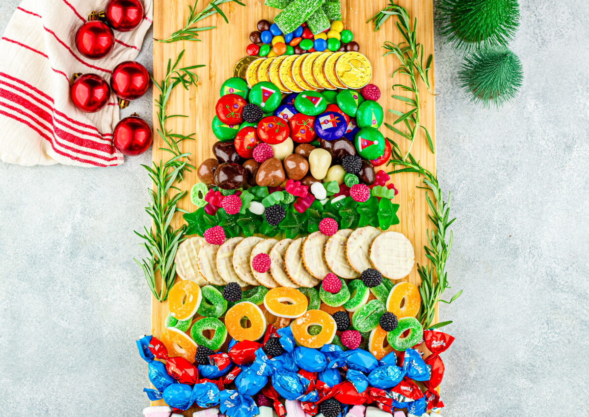layering more candy to make this candy charcuterie christmas tree board