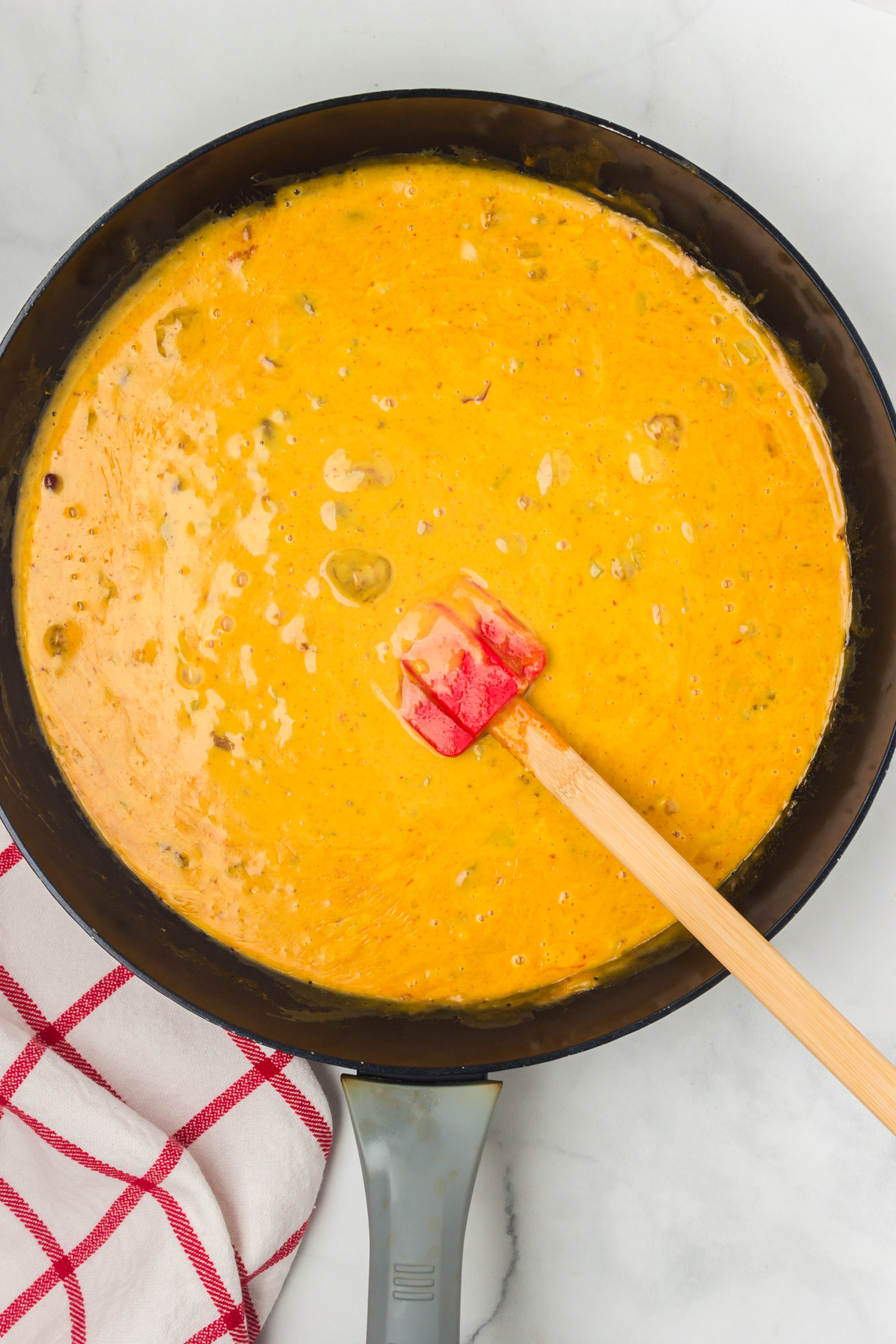 melted hormel chili cheese dip in a pan