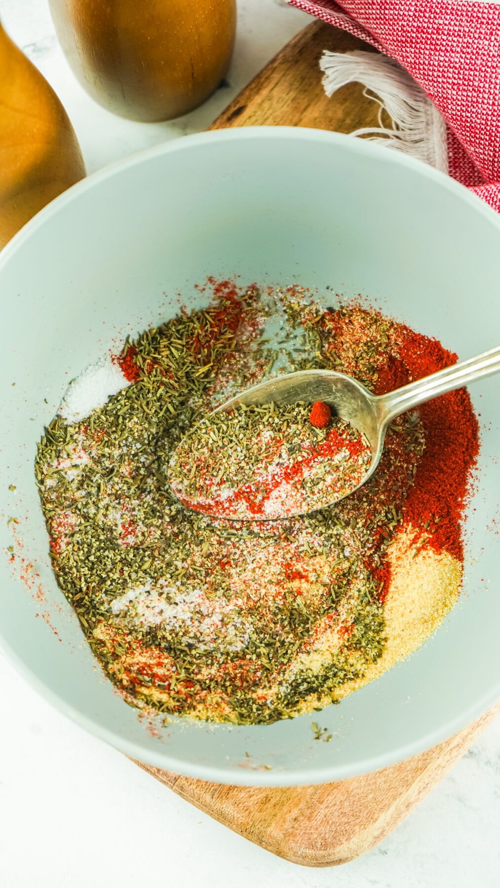 mixing together the herbs and spices for this steak seasoning in a bowl