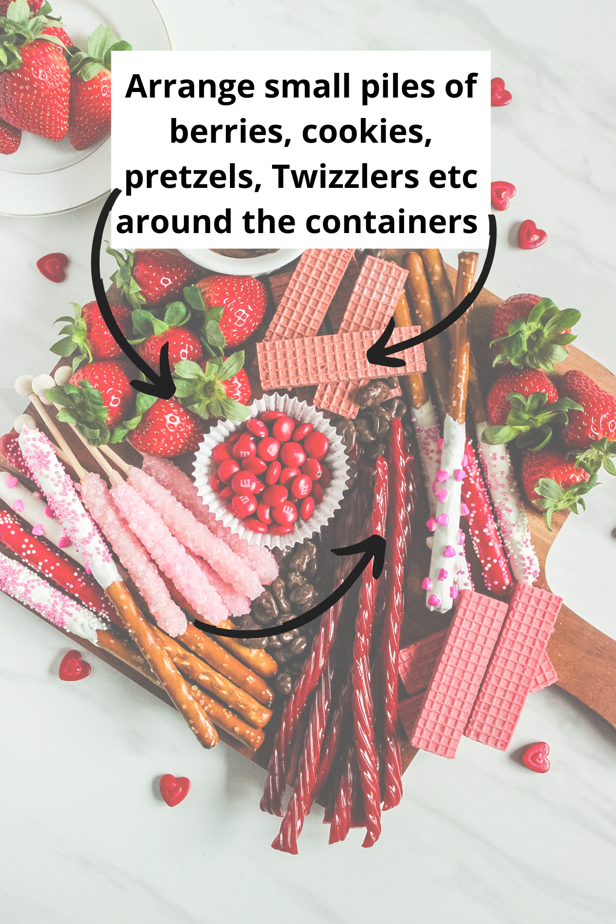 placing the larger food items such as the pretzel rods and twizzlers on the charcuterie board
