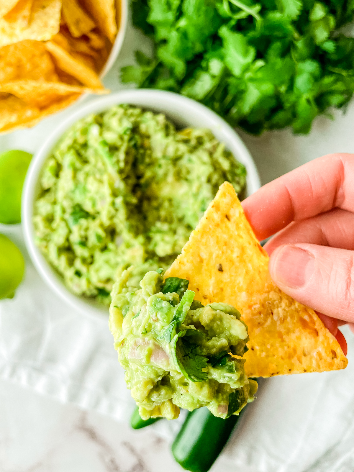 tortilla chip topped with guacamole without tomatoes
