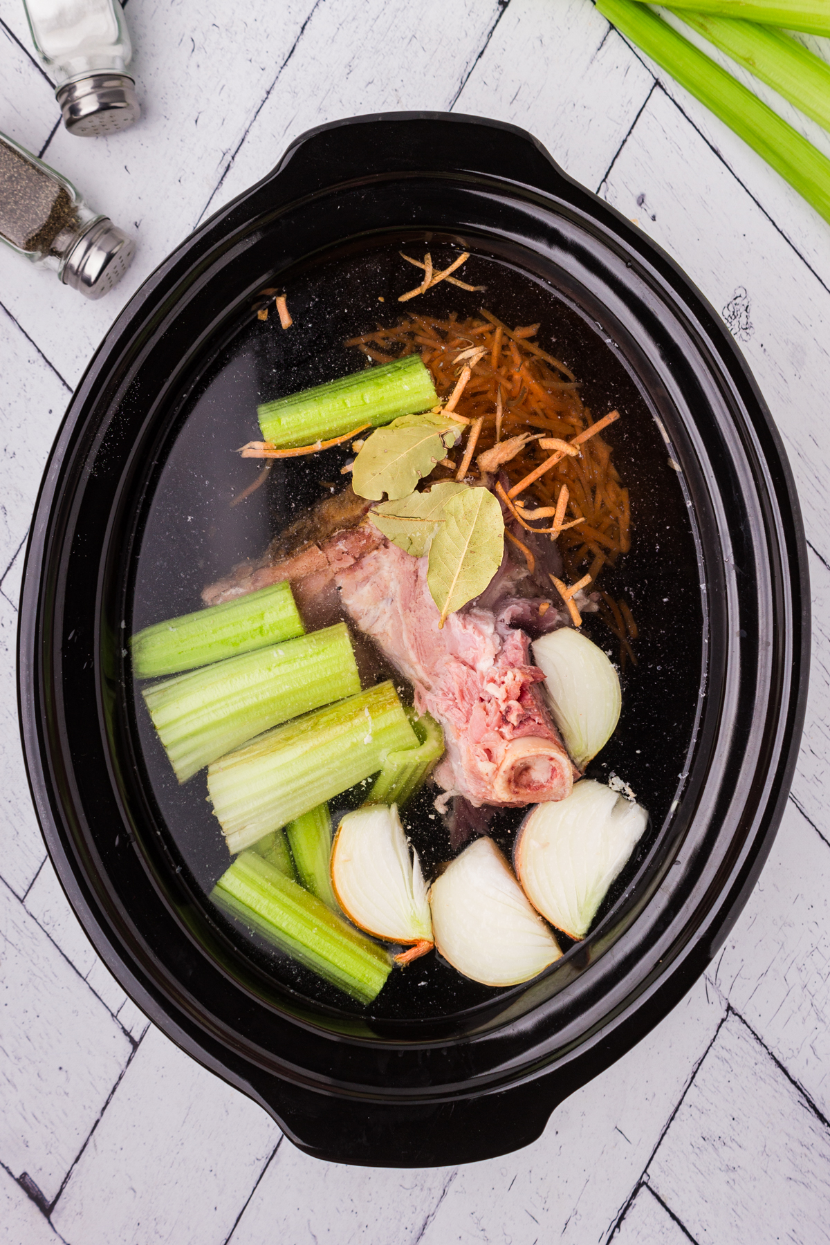 image of slow cooker ham broth ingredients in the crock pot