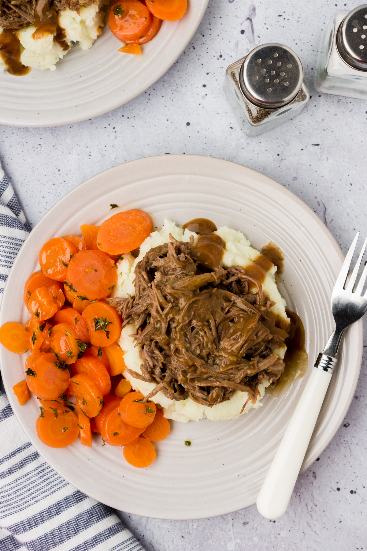 this is the best pot roast for sunday dinner being served on a plate