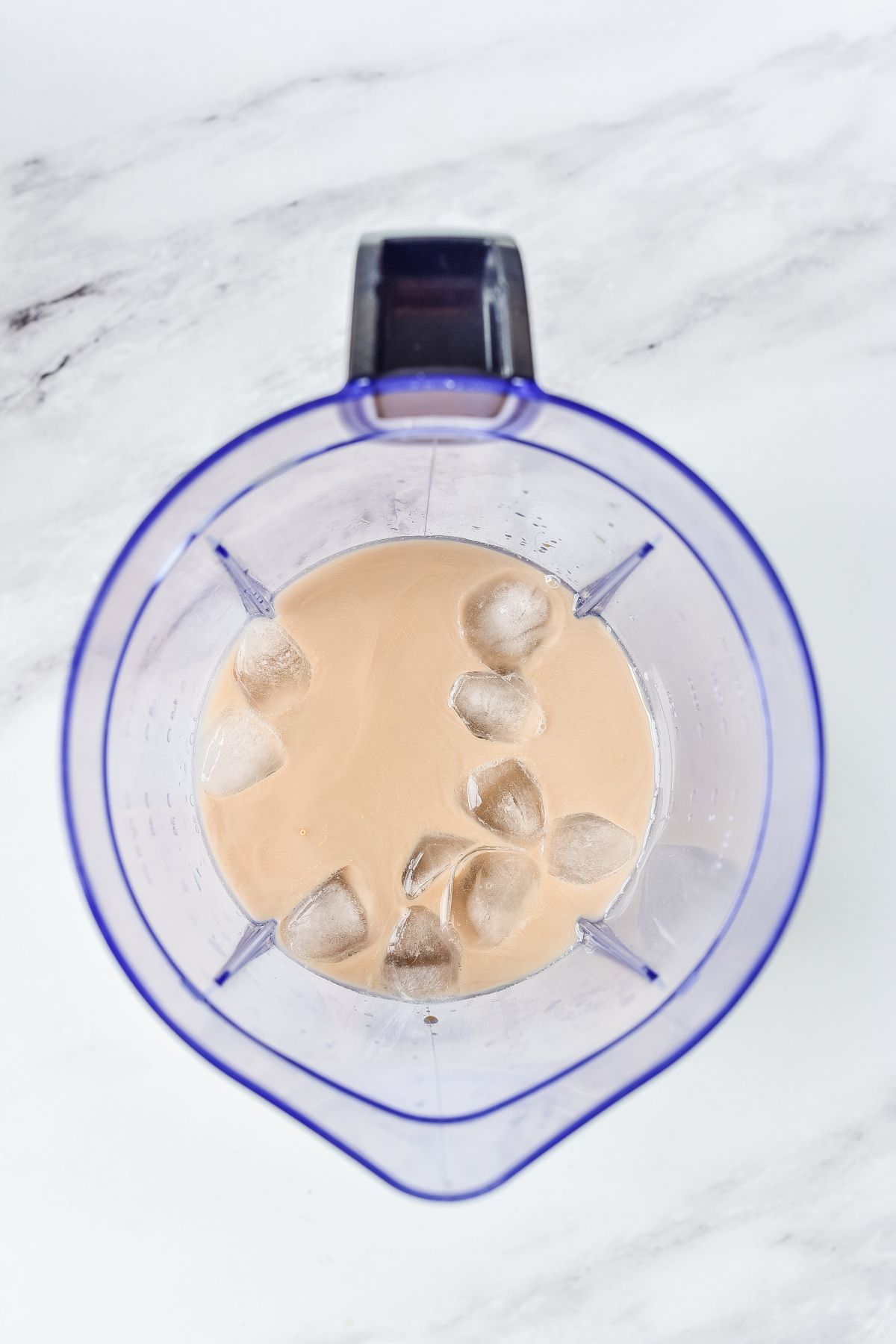 coffee, milk and ice cubes in a blender to make a caramel ribbon crunch creme Frappuccino