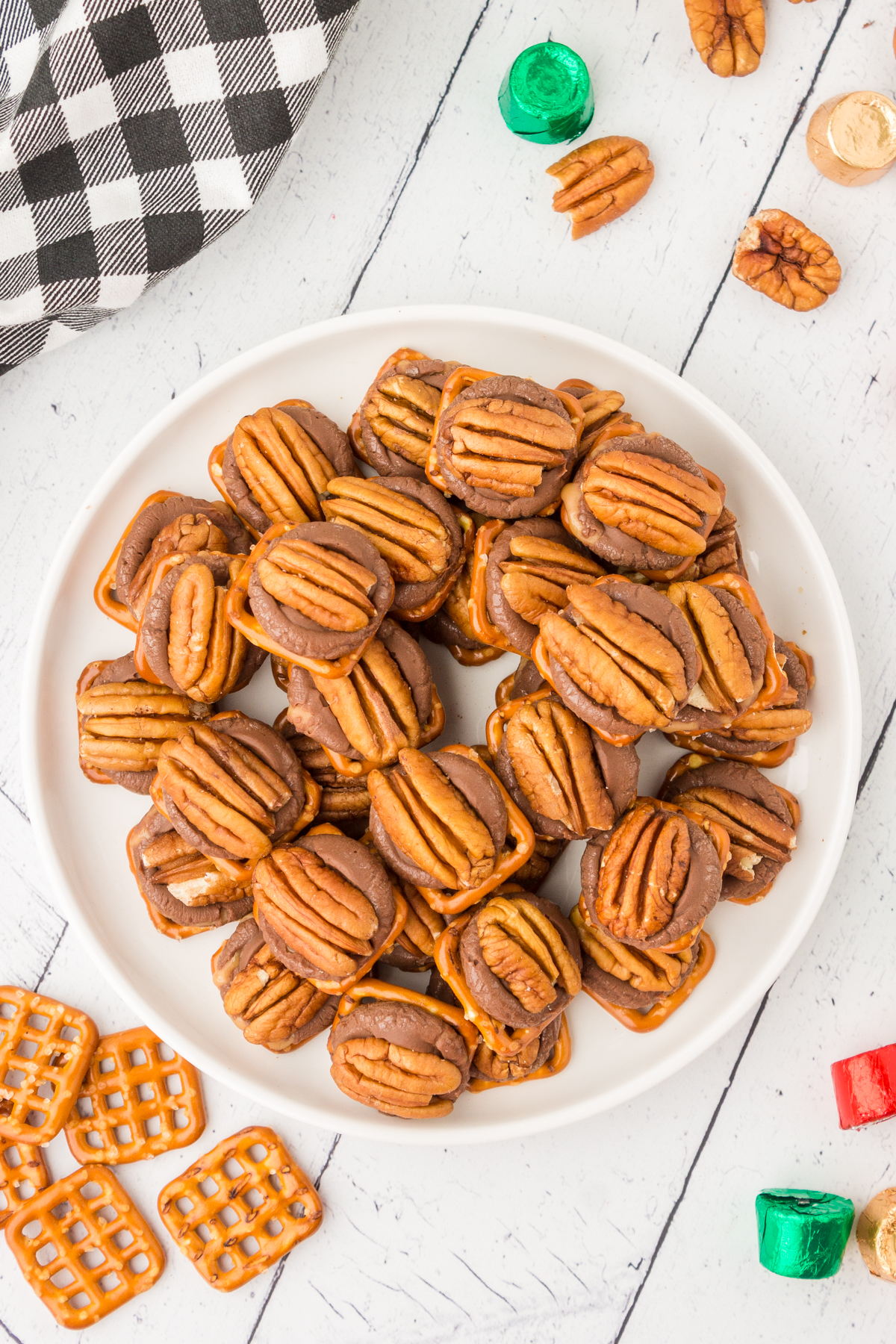 rolo pretzel bites topped with pecan halves on a plate