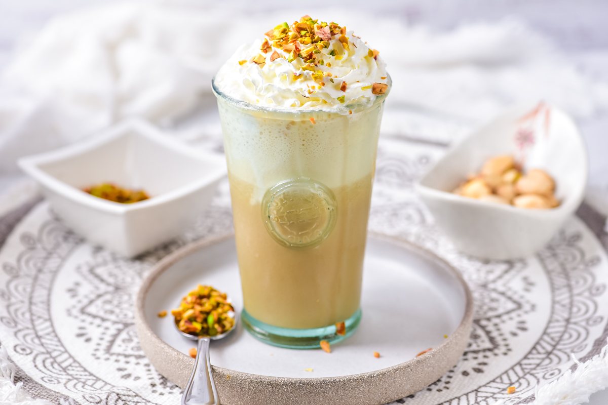 Iced starbucks copycat pistachio latte recipe with whipped topping in a glass