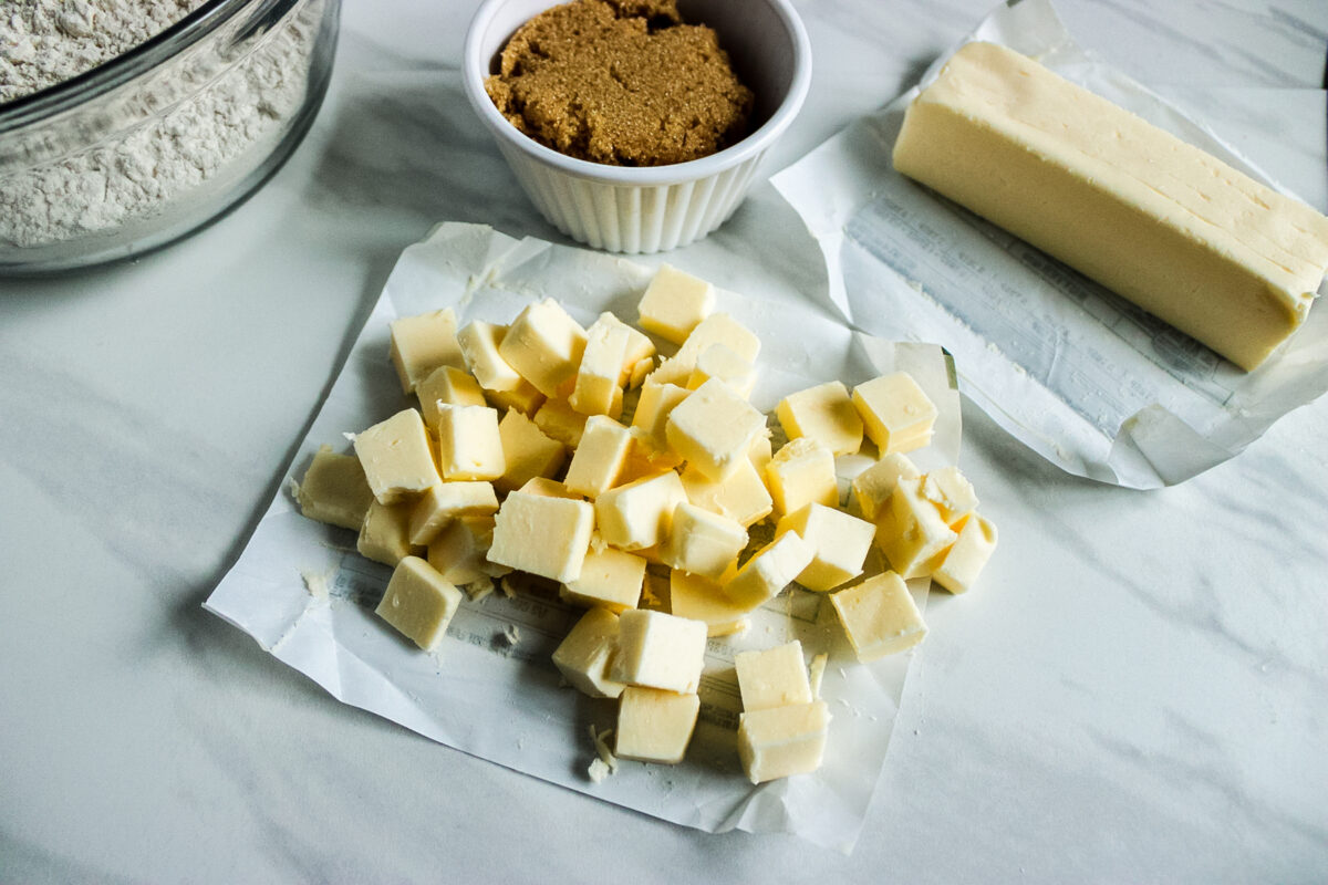 cutting butter into small pieces to make these heart shaped shortbread cookies