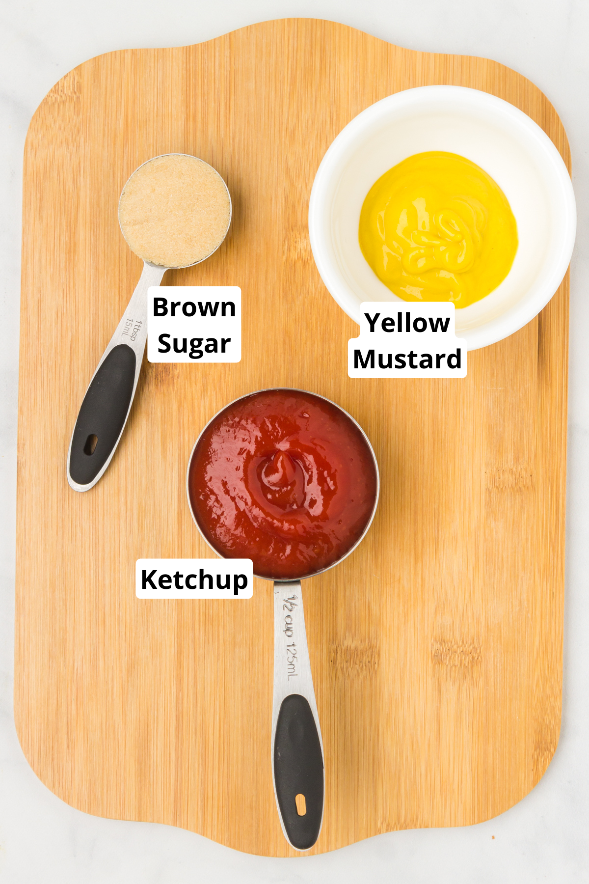 main ingredients to make tangy ketchup dipping sauce on a cutting board