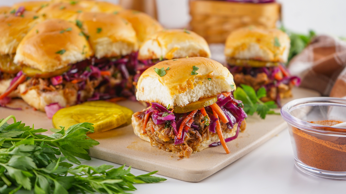 best pulled pork sliders topped with  coleslaw mix on a serving board